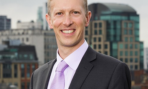 Businessman smiling outdoors.