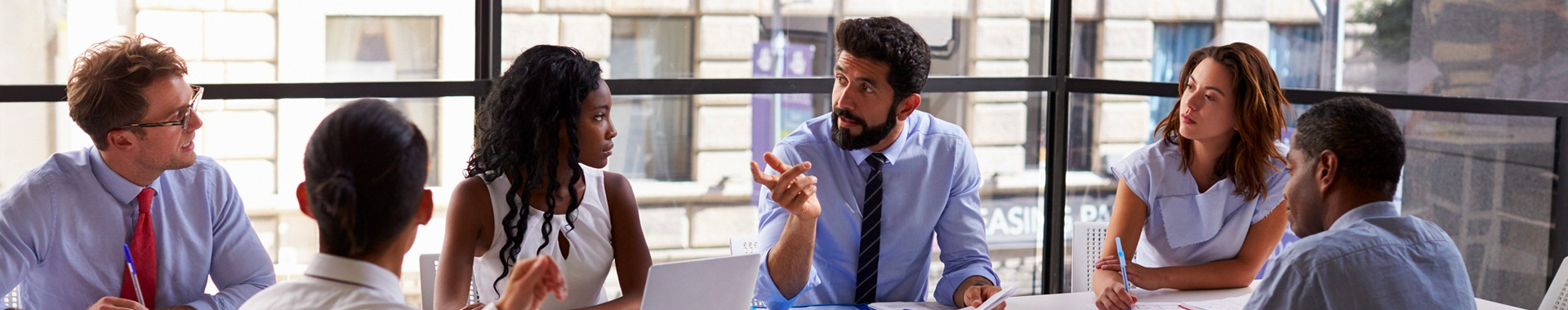 Office discussion around a table.