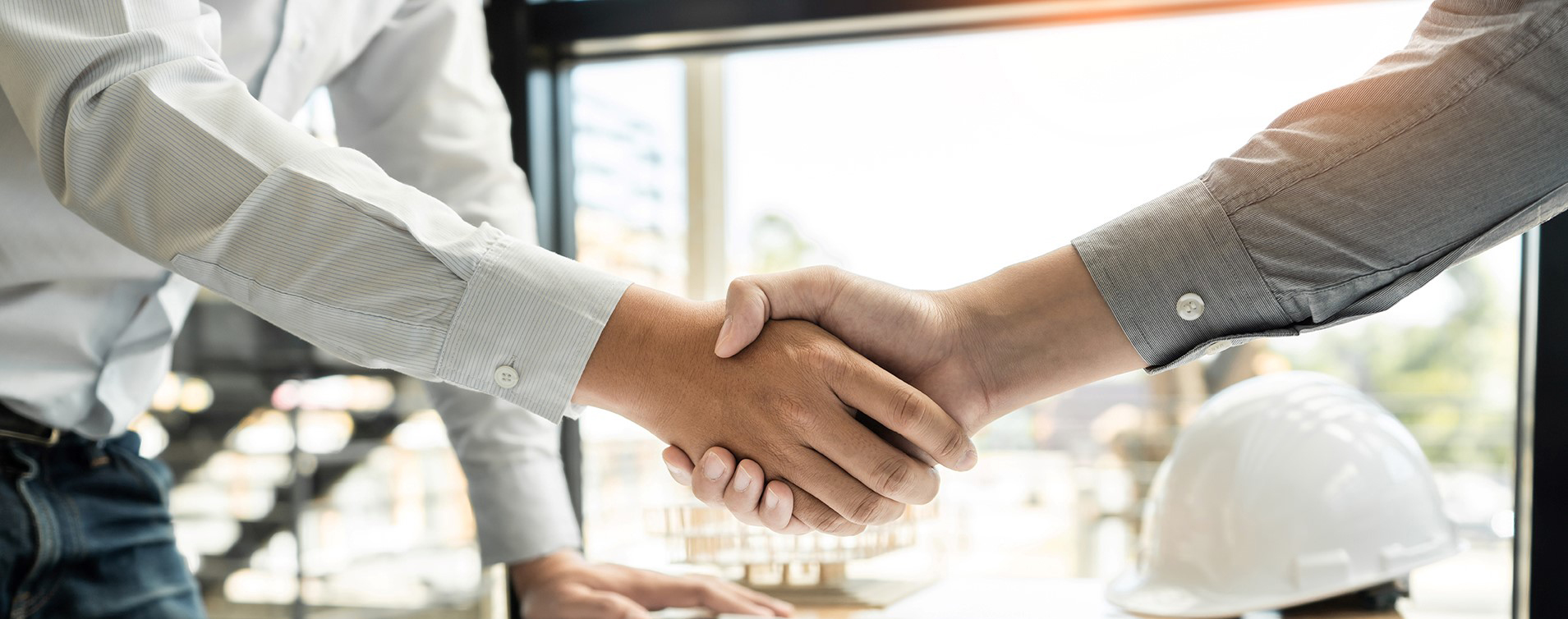 Handshake over construction plans