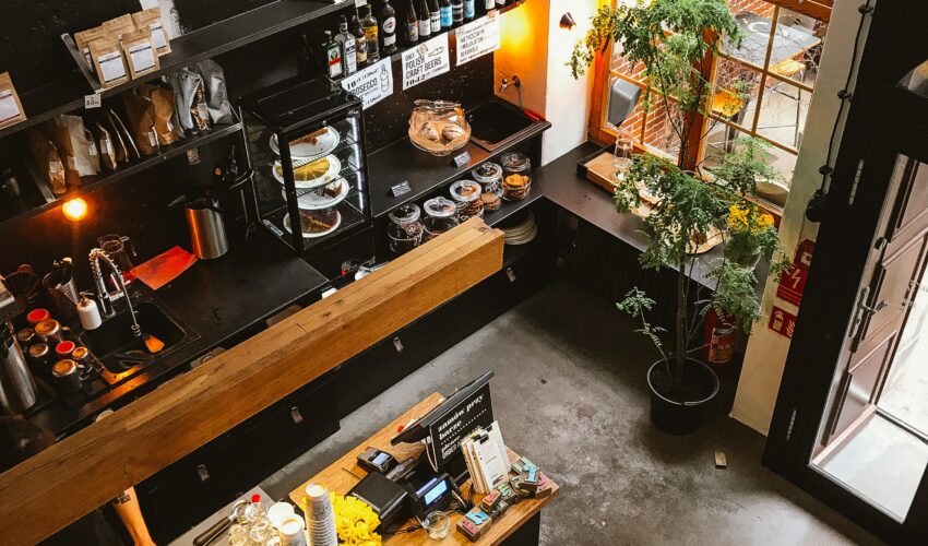 Modern coffee shop interior with wooden counters and a large window.