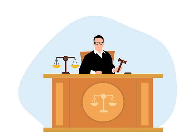 A judge in a black robe sits behind a wooden bench with scales of justice and a gavel.